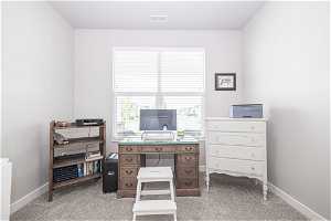 Office space featuring light colored carpet