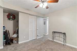 Bonus room featuring a closet, a textured ceiling, carpet floors, and ceiling fan