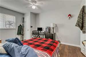 Bedroom featuring dark hardwood / wood-style flooring and ceiling fan