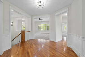 Corridor with light hardwood floors and plenty of natural light