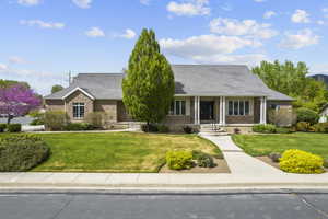 Single story home featuring a front lawn