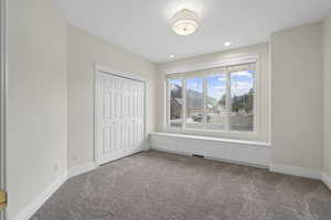 Unfurnished bedroom with a closet and carpet