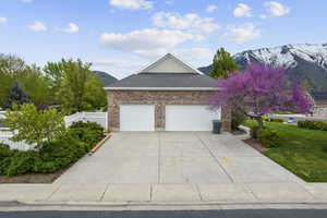 View of side of home with a 3 car garage and a mountain view