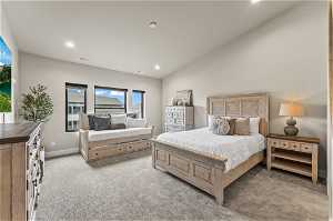Bedroom featuring light carpet and lofted ceiling