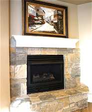 Interior details featuring a stone fireplace next to the Basement family room area