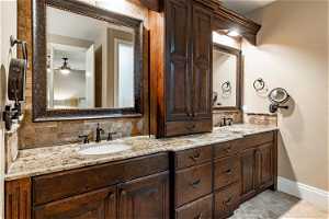 Master Bathroom featuring tasteful backsplash, tile flooring, ceiling fan, and double sink vanity