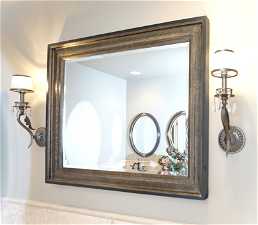 Basement bathroom with mirror and light fixtures