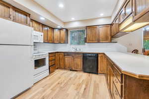 Spacious Kitchen with lots of cabinetry, tons of counter space on the kitchen peninsula, and hardwood  flooring!