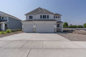 View of front facade featuring a garage