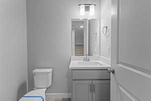 Bathroom featuring large vanity and toilet