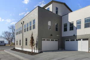 View of side of property with a garage