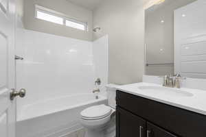 Full bathroom featuring shower / tub combination, oversized vanity, and toilet