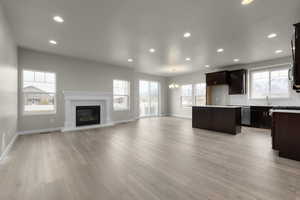 Interior space featuring an inviting chandelier, light hardwood / wood-style flooring, and plenty of natural light