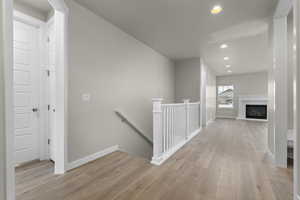 Hallway with light hardwood / wood-style floors