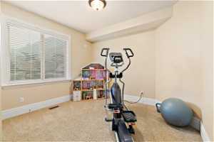 View of carpeted bedroom being used as exercise room