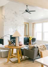 Living room with lofted ceiling, wood-type flooring, and ceiling fan