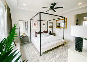 Bedroom with ceiling fan and a tray ceiling