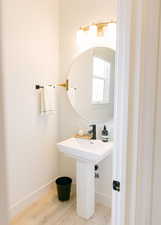 Bathroom featuring wood-type flooring and sink