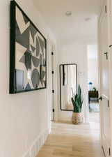 Corridor with light hardwood / wood-style floors