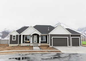 View of front of property with a mountain view and a garage