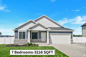 Craftsman-style house featuring a front lawn and a garage