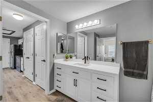 Bathroom with hardwood / wood-style flooring and large vanity
