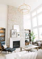 Living room with a towering ceiling and an inviting chandelier