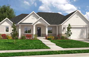 View of front of house with a front yard and a garage