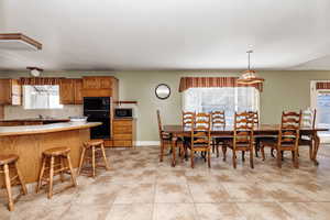 Dining room featuring sink and light tile floors