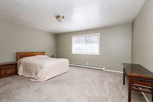 Bedroom featuring carpet flooring and a baseboard radiator