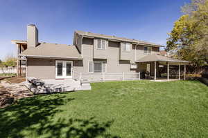 Back of property featuring a patio, french doors, and a lawn