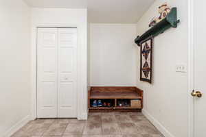 Mudroom with light tile flooring