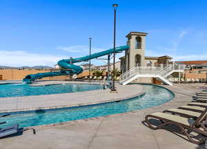 View of swimming pool featuring a water slide and a patio area