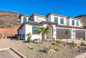 Mediterranean / spanish home featuring a garage