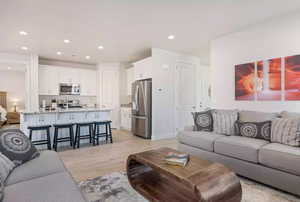 Living room with light hardwood / wood-style floors