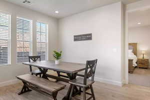 Dining room with light hardwood / wood-style flooring