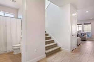 Bathroom with hardwood / wood-style flooring and toilet