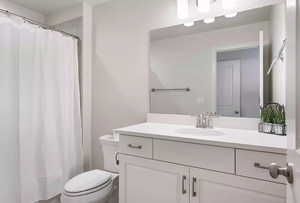 Bathroom featuring oversized vanity and toilet