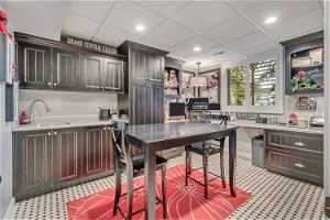 Heated tile flooring, floor to ceiling cabinets, and sink