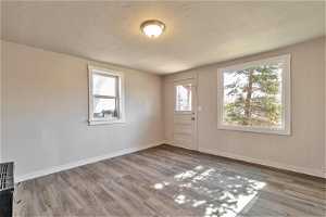 Spare room with plenty of natural light, hardwood / wood-style floors, and a textured ceiling564 Capitol St