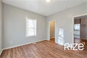 Unfurnished bedroom with a walk in closet and hardwood / wood-style floors2431 B Ave