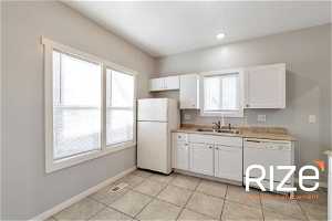 Kitchen featuring white cabinets, white appliances, sink, and light tile floors2431 B Ave