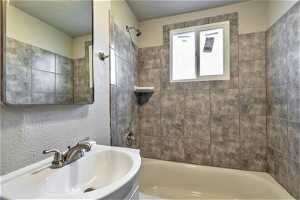 Bathroom featuring tiled shower / bath combo and vanity564 Capitol St