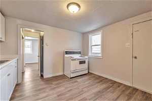 Kitchen with light hardwood / wood-style flooring, electric range, and white cabinets564 Capitol St
