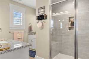 Bathroom with a shower with shower door and vanity