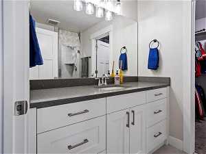 Bathroom with oversized vanity and a textured ceiling