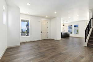 Unfurnished living room featuring sink and dark hardwood / wood-style floors