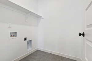 Laundry room featuring washer hookup, hookup for an electric dryer, and dark tile floors