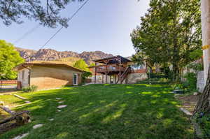 View of yard featuring a deck with mountain view