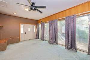 Interior space with crown molding and ceiling fan
